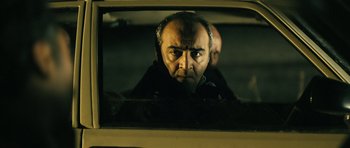 Movie still from “Once Upon a Time in Anatolia” (2011), directed by Nuri Bilge Ceylan – A man looking out of the window of a car; Close Up shot, Over the shoulder angle