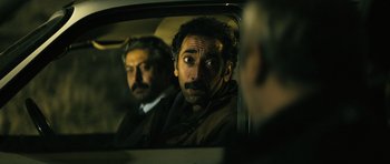 Movie still from “Once Upon a Time in Anatolia” (2011), directed by Nuri Bilge Ceylan – A man in a car looking into a mirror; Close Up shot, Over the shoulder angle