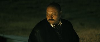 Movie still from “Once Upon a Time in Anatolia” (2011), directed by Nuri Bilge Ceylan – A man with a goatee and a black jacket; Close Up shot, Low angle