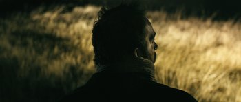 Movie still from “Once Upon a Time in Anatolia” (2011), directed by Nuri Bilge Ceylan – A man with a beard is looking into the distance; Extreme Close Up shot, Over the shoulder angle