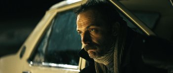 Movie still from “Once Upon a Time in Anatolia” (2011), directed by Nuri Bilge Ceylan – A person wearing a scarf; Close Up shot, Low angle