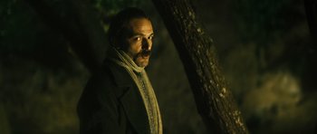 Movie still from “Once Upon a Time in Anatolia” (2011), directed by Nuri Bilge Ceylan – A man with a beard wearing a jacket and a scarf; Close Up shot, Low angle