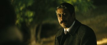 Movie still from “Once Upon a Time in Anatolia” (2011), directed by Nuri Bilge Ceylan – A person wearing a suit and tie; Close Up shot, Over the shoulder angle
