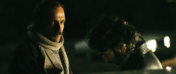 Movie still from “Once Upon a Time in Anatolia” (2011), directed by Nuri Bilge Ceylan – A man standing next to another man in the dark; Close Up shot, Over the shoulder angle