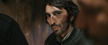 Movie still from “Once Upon a Time in Anatolia” (2011), directed by Nuri Bilge Ceylan – A person wearing a leather jacket; Close Up shot, Over the shoulder angle