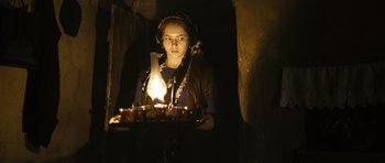 Movie still from “Once Upon a Time in Anatolia” (2011), directed by Nuri Bilge Ceylan – A woman holding a tray with a lit candle on top of it; Medium shot, Low angle