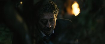 Movie still from “Once Upon a Time in Anatolia” (2011), directed by Nuri Bilge Ceylan – A person wearing a suit and tie; Close Up shot, Over the shoulder angle