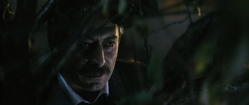 Movie still from “Once Upon a Time in Anatolia” (2011), directed by Nuri Bilge Ceylan – A person wearing a suit and tie; Close Up shot, Low angle