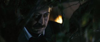Movie still from “Once Upon a Time in Anatolia” (2011), directed by Nuri Bilge Ceylan – A person wearing a suit and tie; Close Up shot, Over the shoulder angle