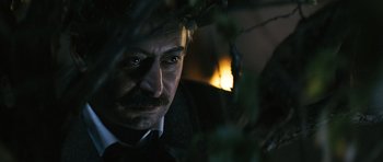 Movie still from “Once Upon a Time in Anatolia” (2011), directed by Nuri Bilge Ceylan – A person wearing a suit and tie; Close Up shot, Over the shoulder angle