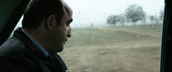 Movie still from “Once Upon a Time in Anatolia” (2011), directed by Nuri Bilge Ceylan – A man looking out of a car window at a field; Close Up shot, Over the shoulder angle