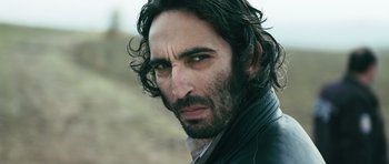 Movie still from “Once Upon a Time in Anatolia” (2011), directed by Nuri Bilge Ceylan – A person wearing a leather jacket; Close Up shot, Low angle