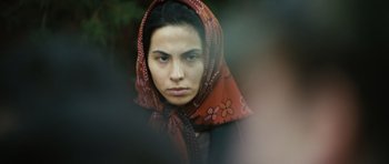 Movie still from “Once Upon a Time in Anatolia” (2011), directed by Nuri Bilge Ceylan – A woman wearing a red head scarf and a black shirt; Close Up shot, Over the shoulder angle