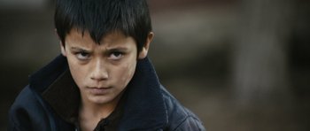 Movie still from “Once Upon a Time in Anatolia” (2011), directed by Nuri Bilge Ceylan – A young boy wearing a black jacket looking at the camera; Close Up shot, High angle