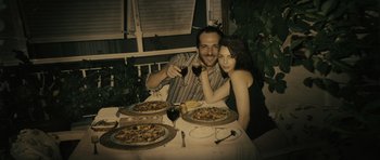 Movie still from “Once Upon a Time in Anatolia” (2011), directed by Nuri Bilge Ceylan – A man and a woman sitting at a dinner table; Medium shot, Overhead angle