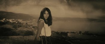 Movie still from “Once Upon a Time in Anatolia” (2011), directed by Nuri Bilge Ceylan – A woman standing on top of a hill holding a purse; Medium shot, High angle