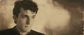 Movie still from “Once Upon a Time in Anatolia” (2011), directed by Nuri Bilge Ceylan – A young man is looking into the camera; Close Up shot, Low angle