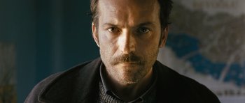 Movie still from “Once Upon a Time in Anatolia” (2011), directed by Nuri Bilge Ceylan – A person with a mustache; Close Up shot, Low angle