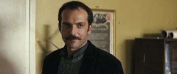 Movie still from “Once Upon a Time in Anatolia” (2011), directed by Nuri Bilge Ceylan – A person wearing a jacket; Close Up shot, Over the shoulder angle