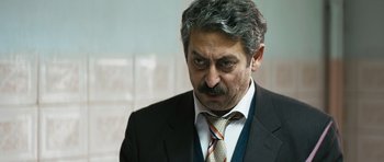Movie still from “Once Upon a Time in Anatolia” (2011), directed by Nuri Bilge Ceylan – A person wearing a suit and tie; Close Up shot, Over the shoulder angle