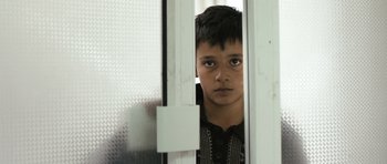 Movie still from “Once Upon a Time in Anatolia” (2011), directed by Nuri Bilge Ceylan – A young boy is looking through a window; Close Up shot, Over the shoulder angle