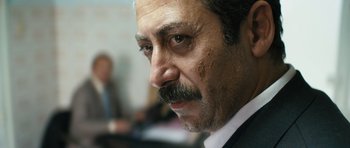 Movie still from “Once Upon a Time in Anatolia” (2011), directed by Nuri Bilge Ceylan – A person with a mustache; Close Up shot, Over the shoulder angle