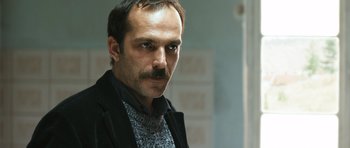 Movie still from “Once Upon a Time in Anatolia” (2011), directed by Nuri Bilge Ceylan – A person with a mustache; Close Up shot, Low angle