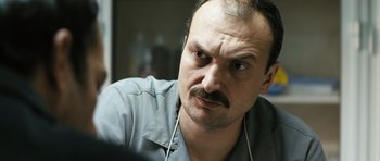 Movie still from “Once Upon a Time in Anatolia” (2011), directed by Nuri Bilge Ceylan – A person with a mustache; Close Up shot, Over the shoulder angle