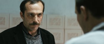 Movie still from “Once Upon a Time in Anatolia” (2011), directed by Nuri Bilge Ceylan – A person with a mustache; Close Up shot, Over the shoulder angle