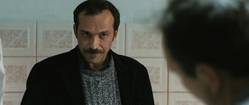 Movie still from “Once Upon a Time in Anatolia” (2011), directed by Nuri Bilge Ceylan – A man with a mustache looking into a mirror; Close Up shot, Over the shoulder angle