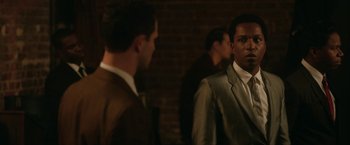 Movie still from “One Night in Miami...” (2020), directed by Regina King – A man in a suit standing next to another man in a suit; Medium shot, Over the shoulder angle