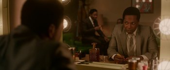 Movie still from “One Night in Miami...” (2020), directed by Regina King – Two men sitting at a table in front of a mirror; Medium shot, Over the shoulder angle