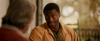 Movie still from “One Night in Miami...” (2020), directed by Regina King – A person wearing a yellow jacket; Close Up shot, Over the shoulder angle