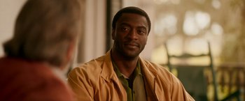 Movie still from “One Night in Miami...” (2020), directed by Regina King – A person wearing a yellow jacket; Close Up shot, Over the shoulder angle