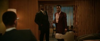 Movie still from “One Night in Miami...” (2020), directed by Regina King – A couple of men standing next to each other in a room; Medium shot, Over the shoulder angle