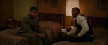 Movie still from “One Night in Miami...” (2020), directed by Regina King – Two men sitting on a bed in a motel room; Medium shot, High angle