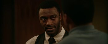 Movie still from “One Night in Miami...” (2020), directed by Regina King – A man wearing a suit and tie talking to another man; Close Up shot, Over the shoulder angle