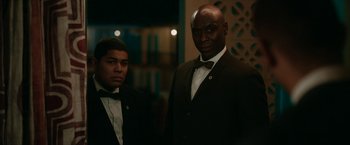 Movie still from “One Night in Miami...” (2020), directed by Regina King – Two men in suits standing next to each other; Medium shot, Low angle