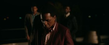 Movie still from “One Night in Miami...” (2020), directed by Regina King – A man in a red jacket and a pink tie; Close Up shot, Over the shoulder angle