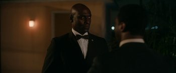 Movie still from “One Night in Miami...” (2020), directed by Regina King – A man in a suit and bow tie standing next to another man in a suit and bow tie; Close Up shot, Over the shoulder angle