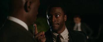 Movie still from “One Night in Miami...” (2020), directed by Regina King – A man in a suit and tie looking at another man in a suit and tie; Close Up shot, Over the shoulder angle