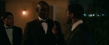 Movie still from “One Night in Miami...” (2020), directed by Regina King – A man in a tuxedo talking to another man in a suit; Medium shot, Over the shoulder angle