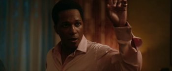 Movie still from “One Night in Miami...” (2020), directed by Regina King – A person wearing a pink shirt; Close Up shot, Over the shoulder angle