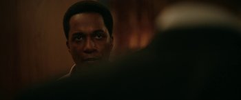 Movie still from “One Night in Miami...” (2020), directed by Regina King – A person looking at a mirror; Close Up shot, Over the shoulder angle