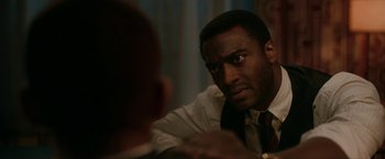 Movie still from “One Night in Miami...” (2020), directed by Regina King – A man in a tie looking at another man in a suit; Close Up shot, Over the shoulder angle