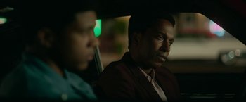 Movie still from “One Night in Miami...” (2020), directed by Regina King – A man sitting in the back of a car next to another man; Close Up shot, Over the shoulder angle