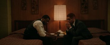 Movie still from “One Night in Miami...” (2020), directed by Regina King – A couple of men sitting next to each other at a table; Medium shot, High angle