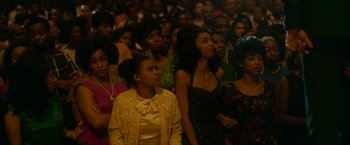 Movie still from “One Night in Miami...” (2020), directed by Regina King – A group of people sitting in a room watching a performance; Medium shot, High angle