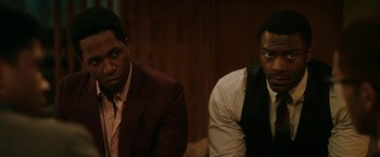 Movie still from “One Night in Miami...” (2020), directed by Regina King – A couple of men sitting next to each other in a room; Medium shot, Over the shoulder angle