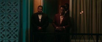 Movie still from “One Night in Miami...” (2020), directed by Regina King – A group of men standing next to each other in a room; Medium shot, Low angle